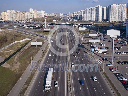 A bird's eye aerial view from drone to the Kharkivskiy district of Kiev, Ukraine with highway, road junction and modern buildings. A bird's eye aerial view from drone to the Kharkivskiy district of Kiev, Ukraine with highway, road junction and modern buildings.
