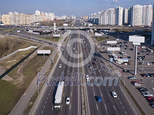 A bird's eye aerial view from drone to the Kharkivskiy district of Kiev, Ukraine with highway, road junction and modern buildings.