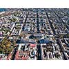 Aerial view of a drone on the city of Odessa with a shopping center, streets with cars and buildings on a sunny summer day, Ukraine.