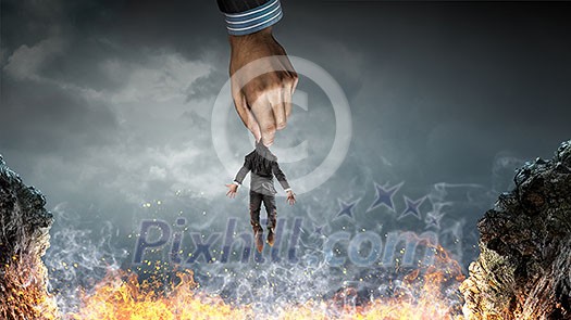 Male hand catching little businessman. Mixed media Male hand catching little businessman. Mixed media