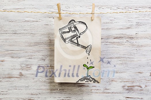 Paper sheet hanging on rope against wooden surface. Mixed media Paper sheet hanging on rope against wooden surface. Mixed media