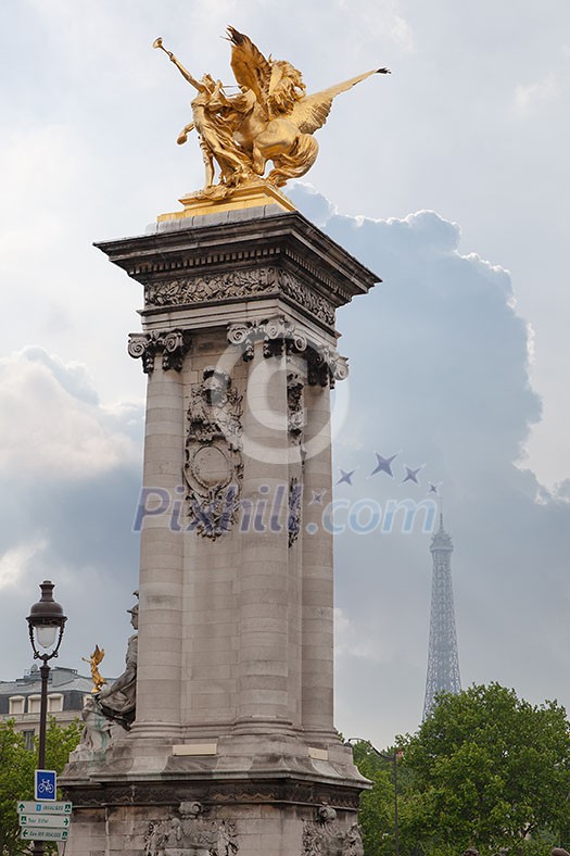 Sculpture on Alexandre III bridge. Pont Alexandre III is an arch famous bridge that spans Seine, connecting Champs-Elysees quarter and Invalides. It is a historical monument. Paris, France.