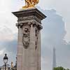 Sculpture on Alexandre III bridge. Pont Alexandre III is an arch famous bridge that spans Seine, connecting Champs-Elysees quarter and Invalides. It is a historical monument. Paris, France.