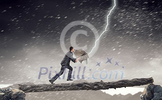 Businessman protects himself from the crisis. Mixed media Businessman protects himself from the crisis. Mixed media
