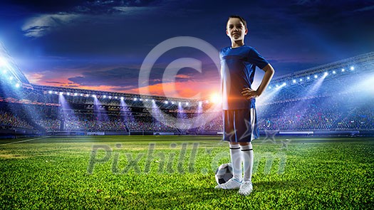 Kid boy in uniform on soccer field looking away. Mixed media