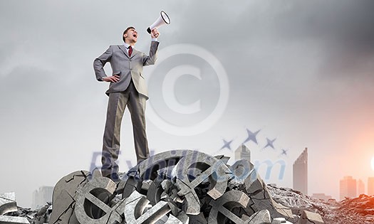 Low angle view of businessman looking like giant. Mixed media Low angle view of businessman looking like giant. Mixed media