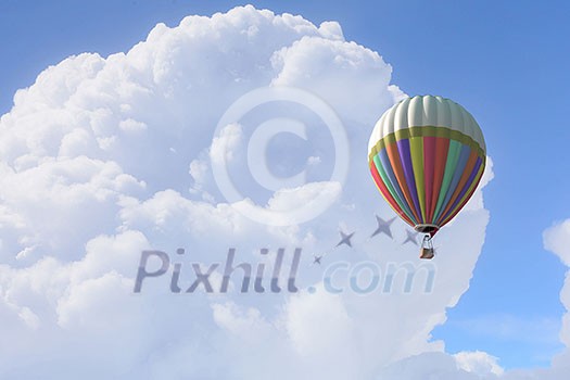 Colorful hot air balloon in blue sky. Mixed media
