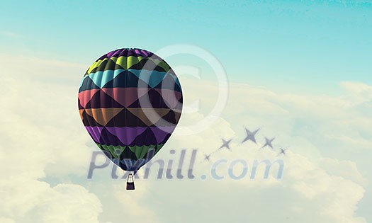 Colorful hot air balloon in blue sky. Mixed media Colorful hot air balloon in blue sky. Mixed media