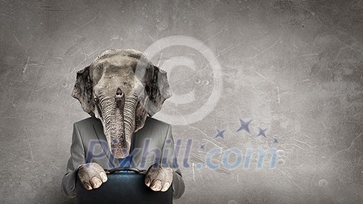 Businessman with elephant head and suitcase in hands. Mixed media