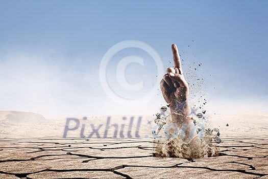 Hand coming out of ground as concept for never give up