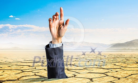 Hand coming out of ground as concept for never give up Hand coming out of ground as concept for never give up