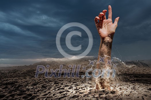 Hand coming out of ground as concept for never give up Hand coming out of ground as concept for never give up