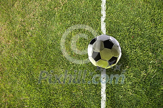 Traditional soccer ball on soccer green field