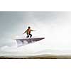 Teenager guy surfing the sky on paper plane. Mixed media