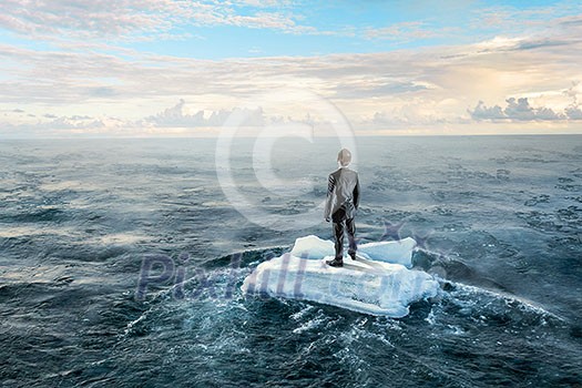 Businessman on ice block floating in sea . Mixed media