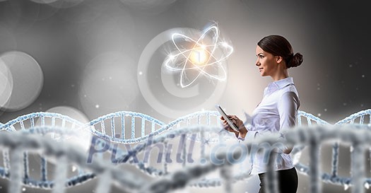 Attractive scientist woman with tablet pc in dark lab. Mixed media Attractive scientist woman with tablet pc in dark lab. Mixed media