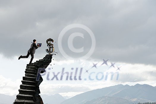 Businessman with laptop in hands running on stone stairway. Mixed media