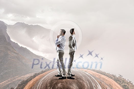 Two businessmen standing back to back and looking away. Mixed media Two businessmen standing back to back and looking away. Mixed media