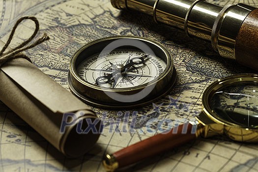 Concept of travel and discovery with old map and compass on it