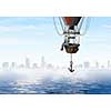 Color aerostat flying above sea and businessman with mobile phone