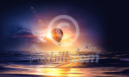 Color aerostat flying above sea as freedom and travel concept Color aerostat flying above sea as freedom and travel concept