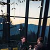 young happy loving couple enjoying romantic dinner while celebrating Valentines day near the window at luxury restaurant