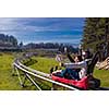 Excited young couple driving alpine coaster while enjoying beautiful sunny day in the nature