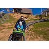 Excited young father and son driving on alpine coaster while enjoying beautiful sunny day in the nature