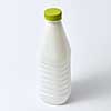Plastic blank white bottle for milk and other liquid with green cap on a light gray background, copy space.