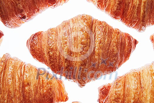 Close up french homemade crispy croissants pattern on a white background. Continental breakfast concept. Close up french homemade crispy croissants pattern on a white background. Continental breakfast concept.