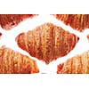Close up french homemade crispy croissants pattern on a white background. Continental breakfast concept.