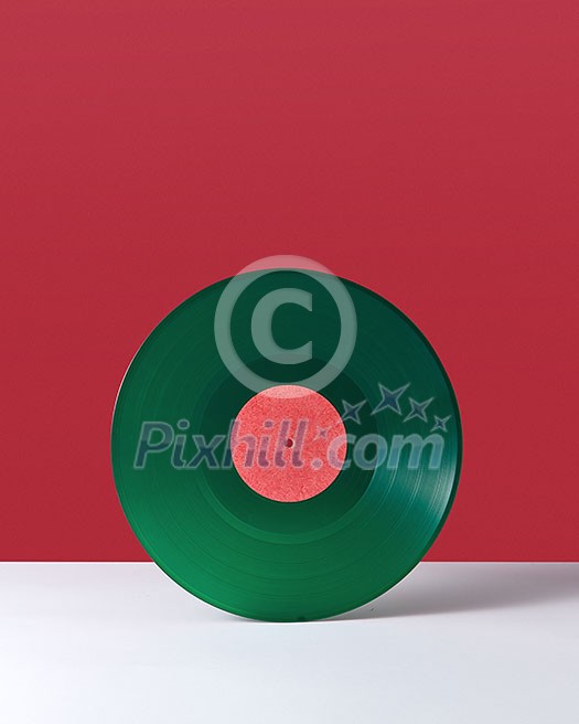 Green music record, on a double white red background with space for text. Retro audio technology