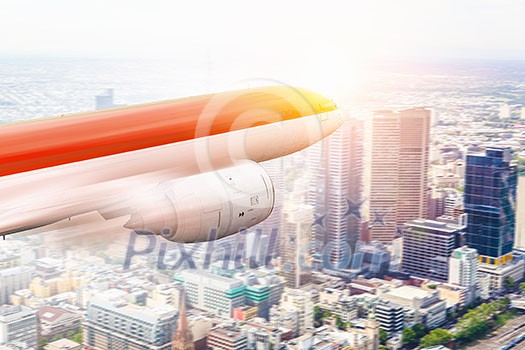 Airliner flying high in sky above modern cityscpe . Mixed media Airliner flying high in sky above modern cityscpe . Mixed media