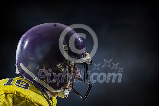 American football player on dark sky background