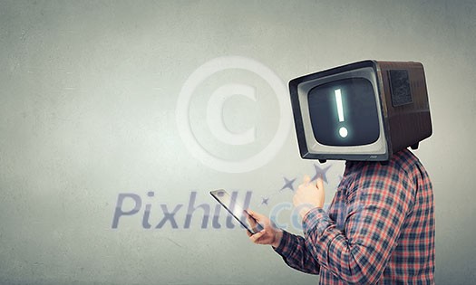 Man with TV monitor instead of head using tablet pc. Mixed media Man with TV monitor instead of head using tablet pc. Mixed media