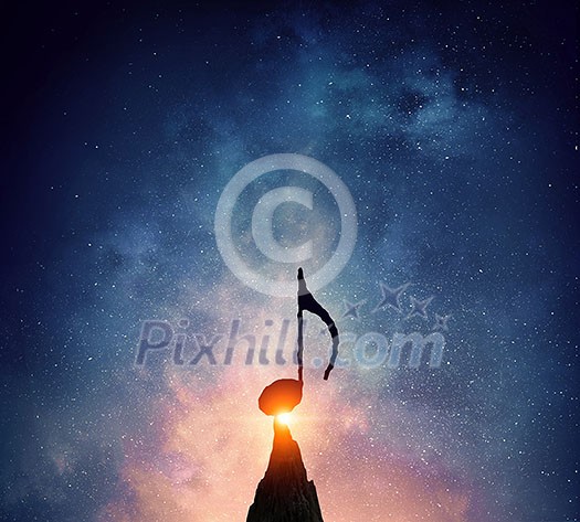 Silhouette of music sign on rock peak against starry sky. Mixed media Silhouette of music sign on rock peak against starry sky. Mixed media