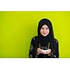 modern muslim woman holding a plate full of sweet dates on iftar time in ramadan kareem islamic healthy food concept ufo green background