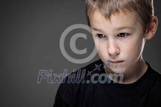 Grief-stricken little boy - feeling intense sorrow, remorse, sadnesss - studio portrait - vivid emotions series Grief-stricken little boy - feeling intense sorrow, remorse, sadnesss - studio portrait - vivid emotions series
