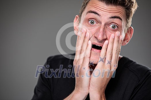 Fear/anxiety/regret/uncertainty in a young man - effects of a difficult life situation - vivid emotions concept Fear/anxiety/regret/uncertainty in a young man - effects of a difficult life situation - vivid emotions concept