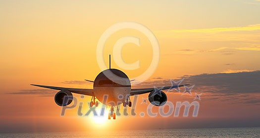 Airplane flying in air against sunset background