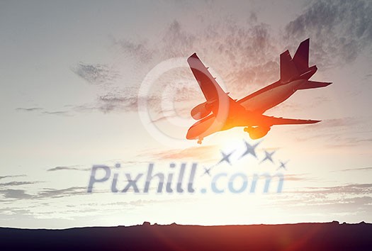 Airplane flying in air against sunset background Airplane flying in air against sunset background