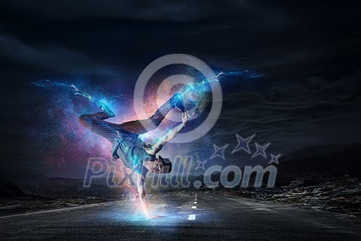 Breakdancer in jump against night sky background. Mixed media