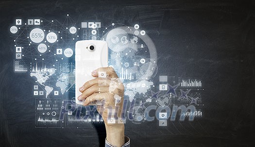 Hand holding smartphone with media application icons Hand holding smartphone with media application icons