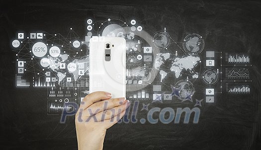 Hand holding smartphone with media application icons Hand holding smartphone with media application icons