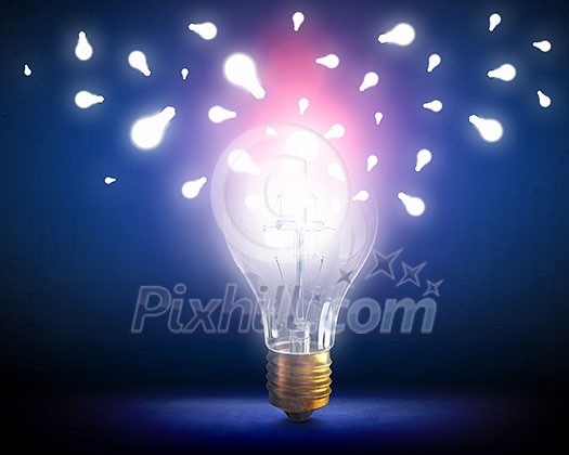 Glowing bright light bulb on dark background