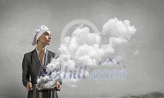 Young elegant businesswoman in suit and cook hat with pan in hands. Mixed media Young elegant businesswoman in suit and cook hat with pan in hands. Mixed media