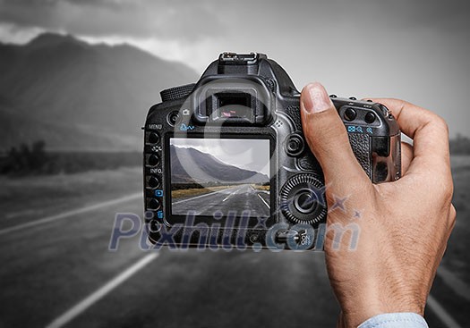 Close of professional photographer holding photo camera