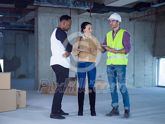 young multiethnic team of business people in group, architect and engineer on construction site checking documents and business workflow using laptop and tablet computer in new startup office young multiethnic team of business people in group, architect and engineer on construction site checking documents and business workflow using laptop and tablet computer in new startup office