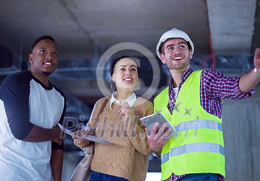 young multiethnic team of business people in group, architect and engineer on construction site checking documents and business workflow using tablet computer in new startup office young multiethnic team of business people in group, architect and engineer on construction site checking documents and business workflow using tablet computer in new startup office