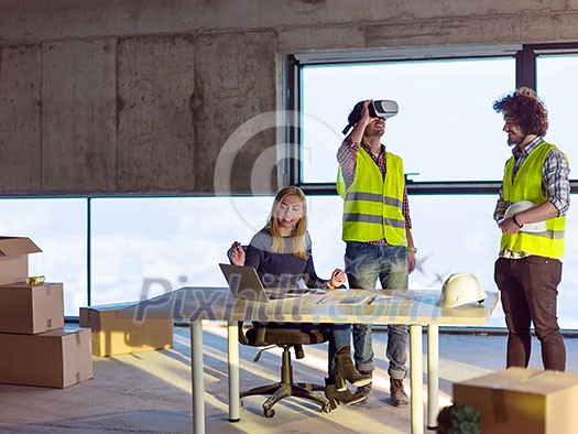 young team of business people in group, architect and engineer on construction site checking documents and business workflow using the virtual reality headset and laptop computer in new startup office